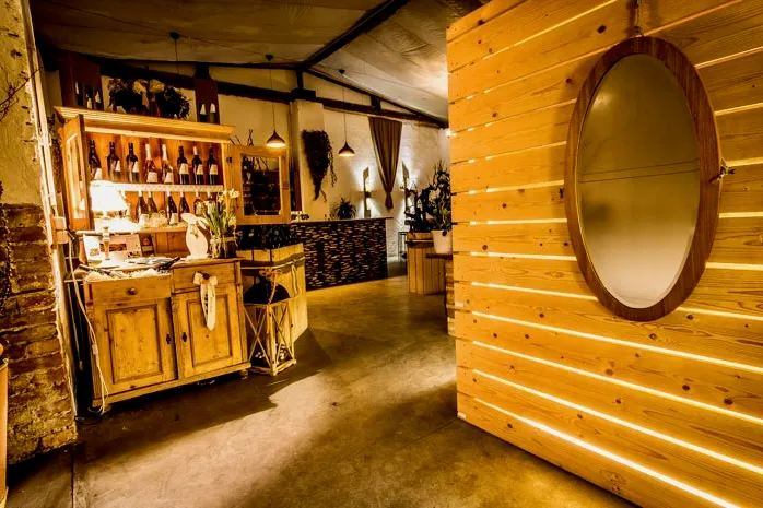 Weingut Artner tasting room, wood-paneled cellar with bottle display and warm lighting