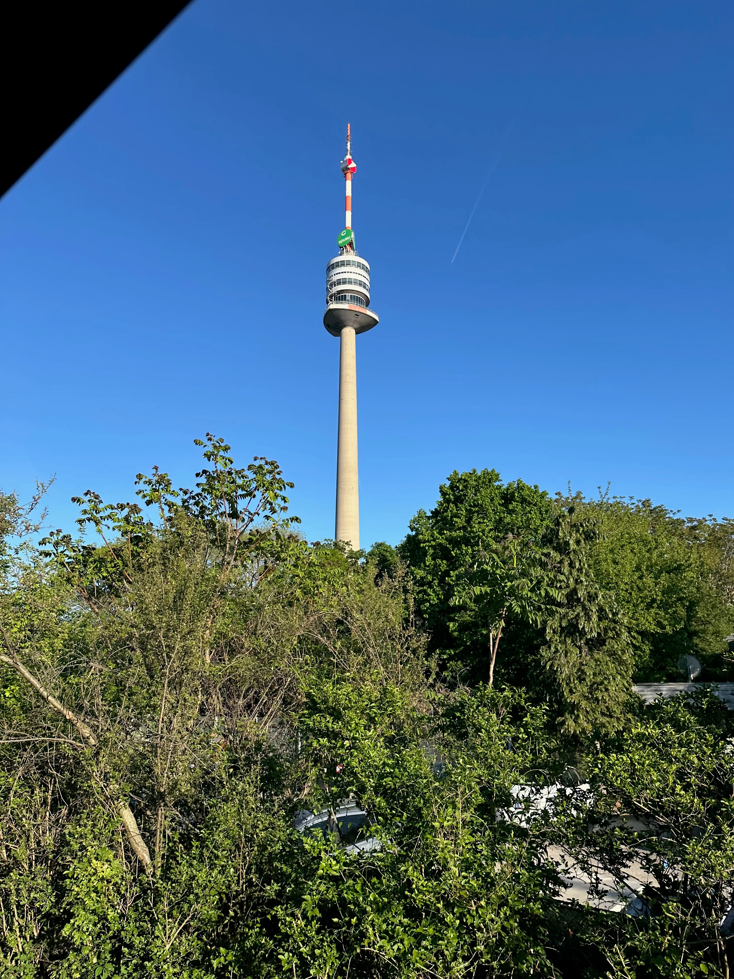 The Donauturm (Danube Tower) rising above the trees near Donauinsel