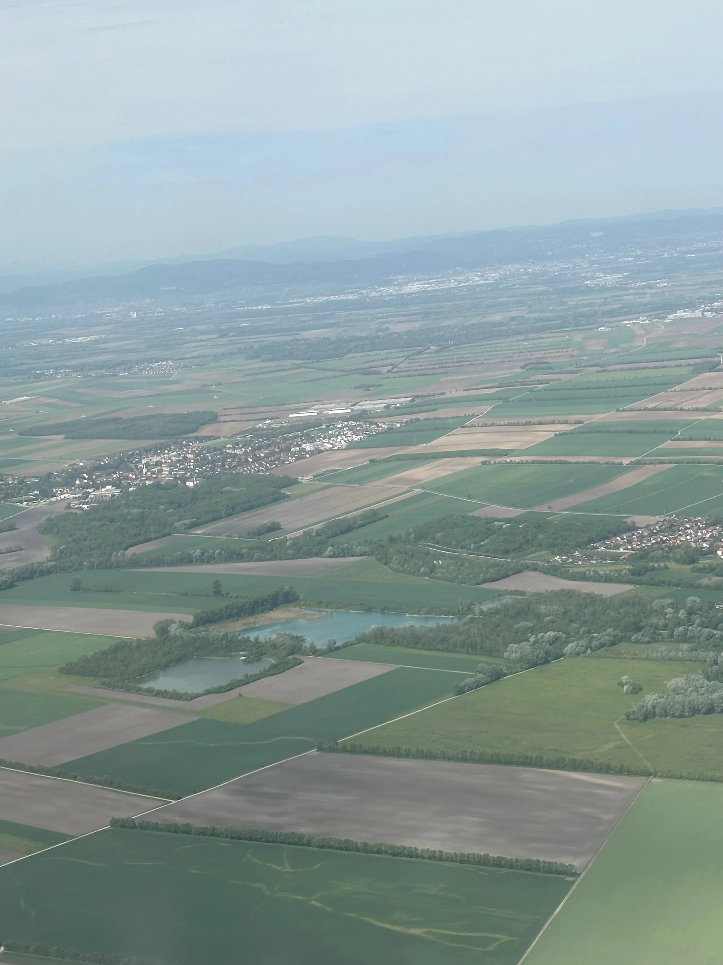 Austrian countryside from cruising altitude — fields, villages, distant hills