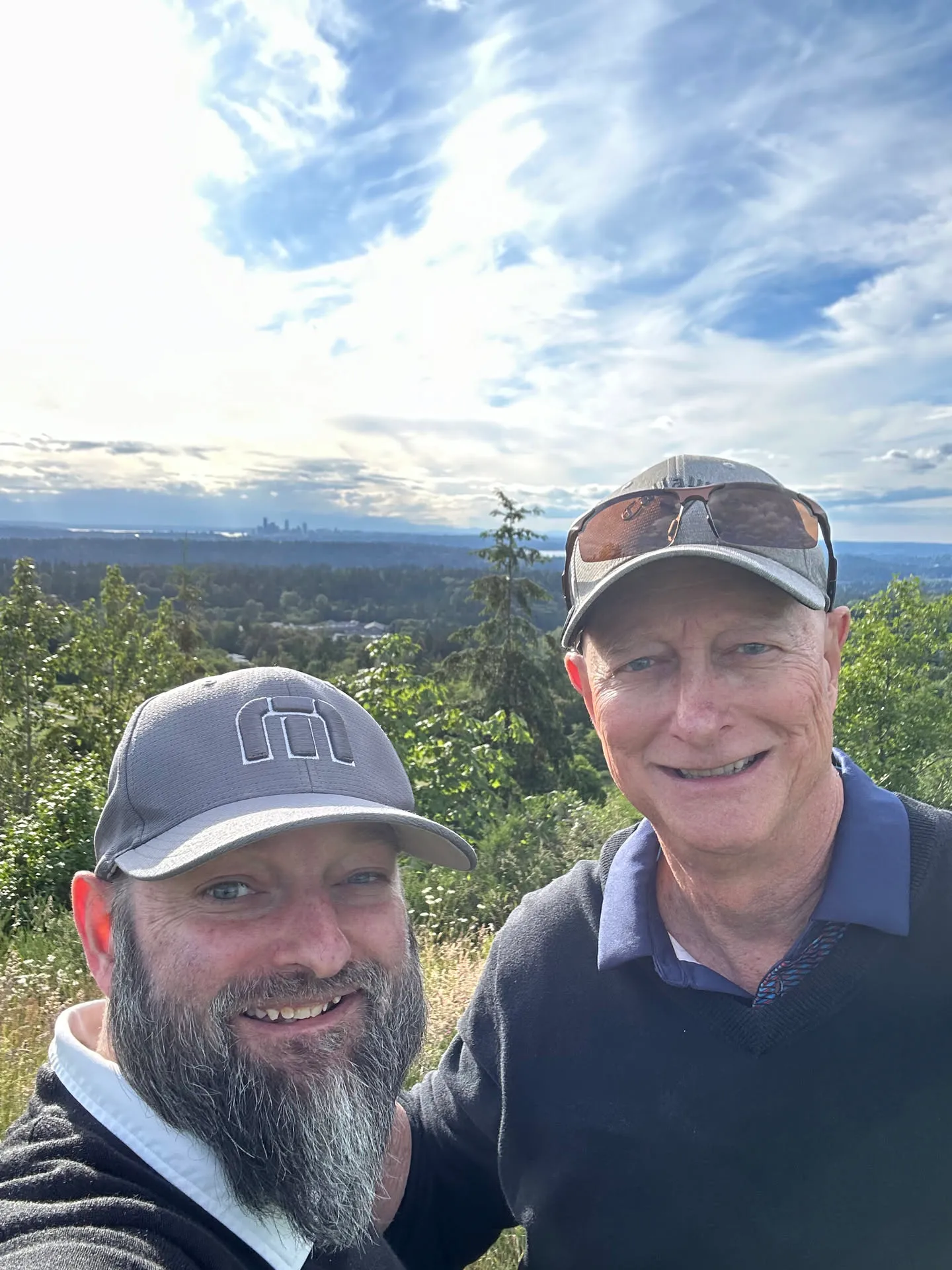 My dad and me on the course, the skyline behind us