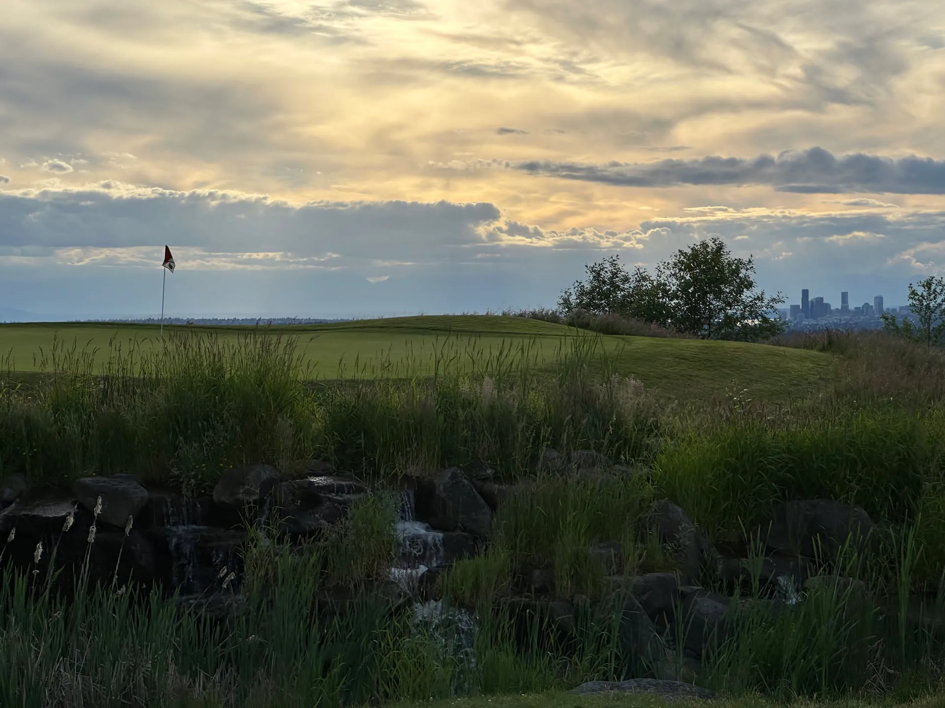 A green and flagstick at golden hour