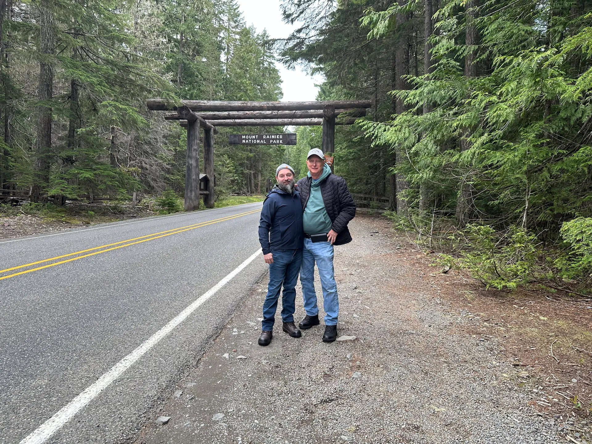 My dad and me at the Mount Rainier National Park entrance arch