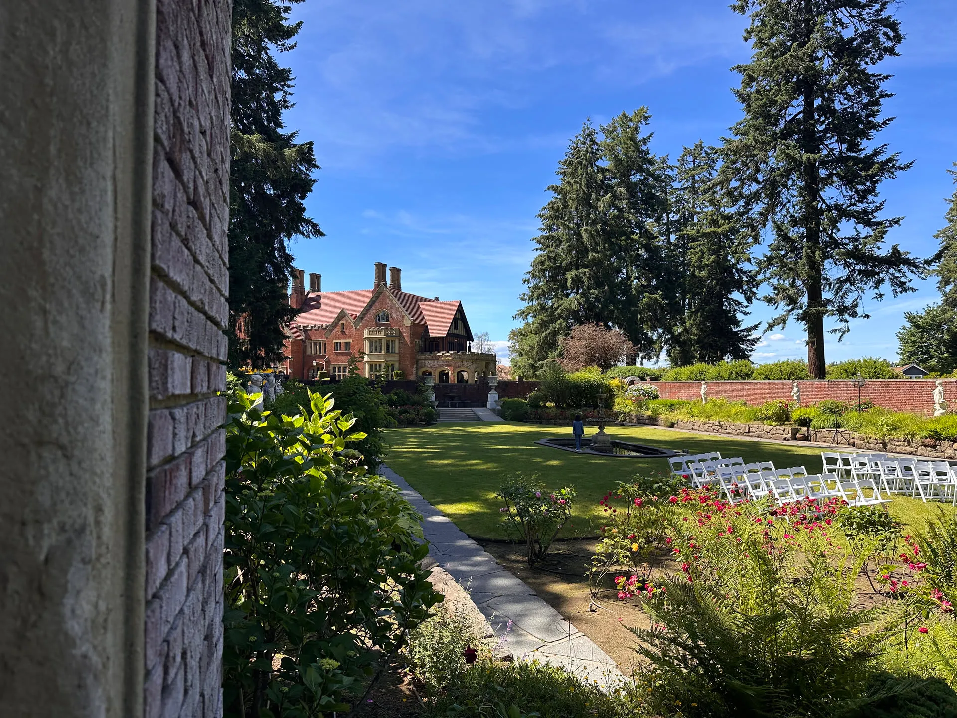 Thornewood Castle and its formal garden, ceremony chairs set out on the lawn