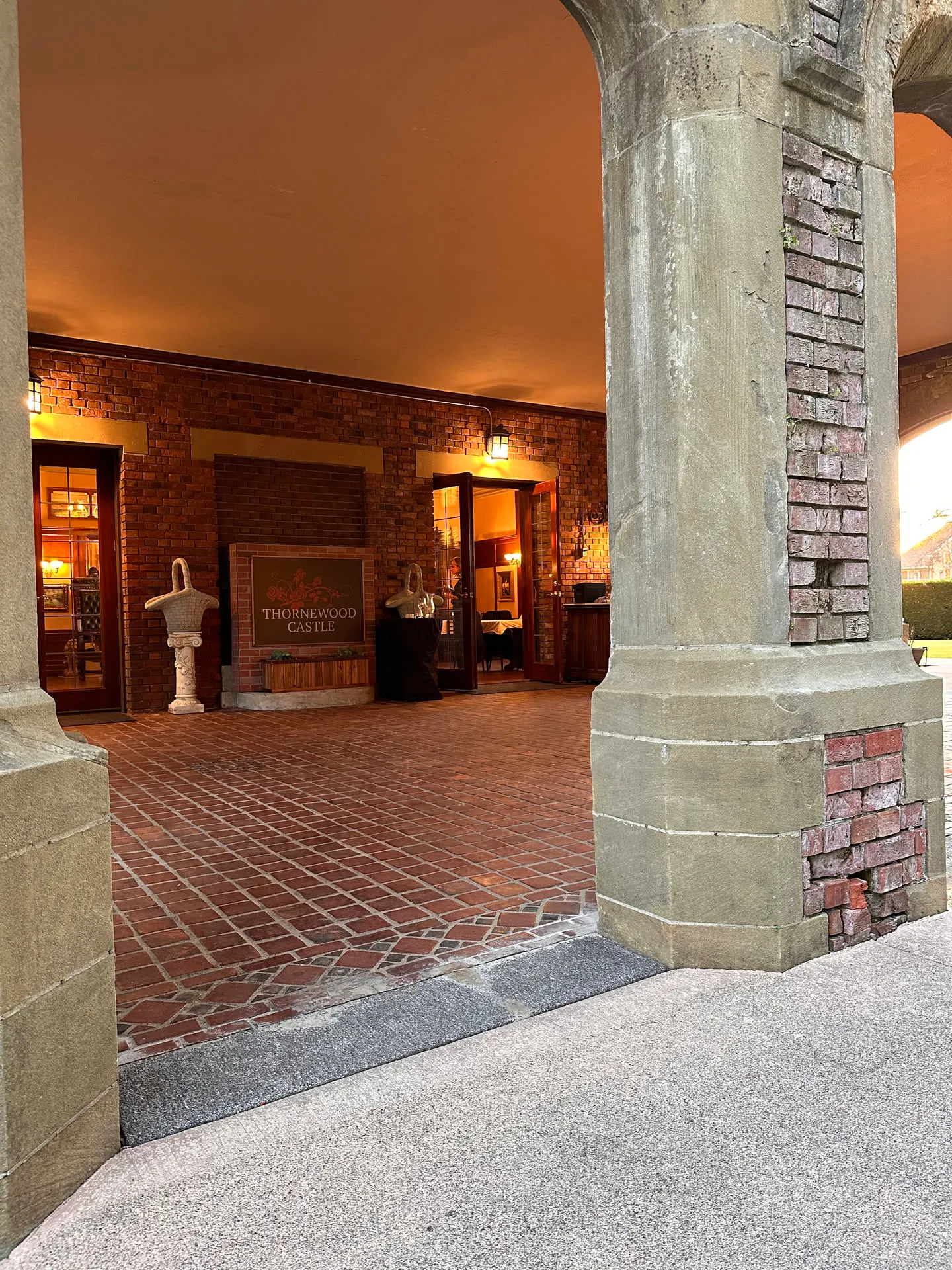 Thornewood's brick loggia lit warm at dusk