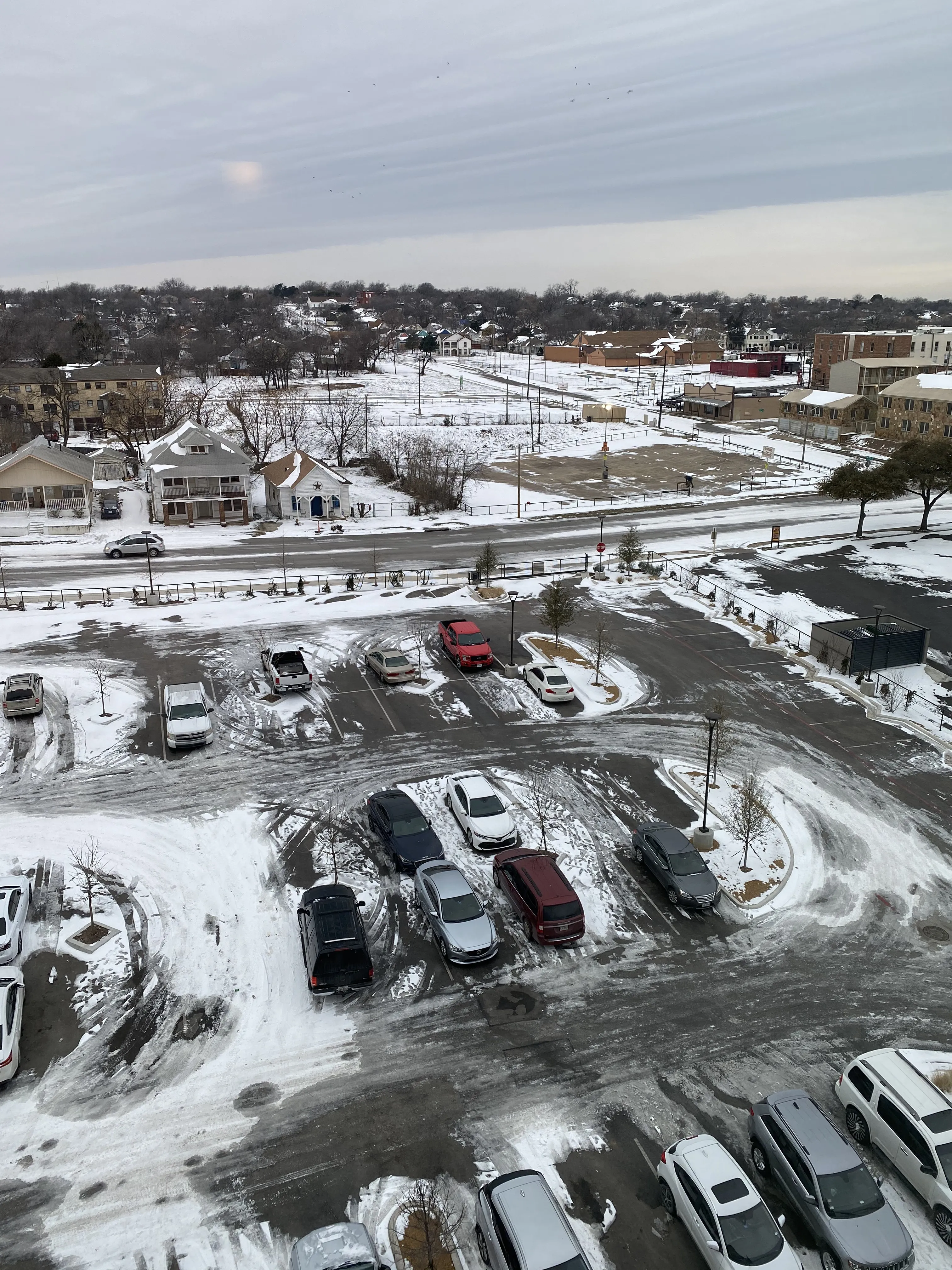 A snow-covered parking lot in Fort Worth—rare sight in Texas