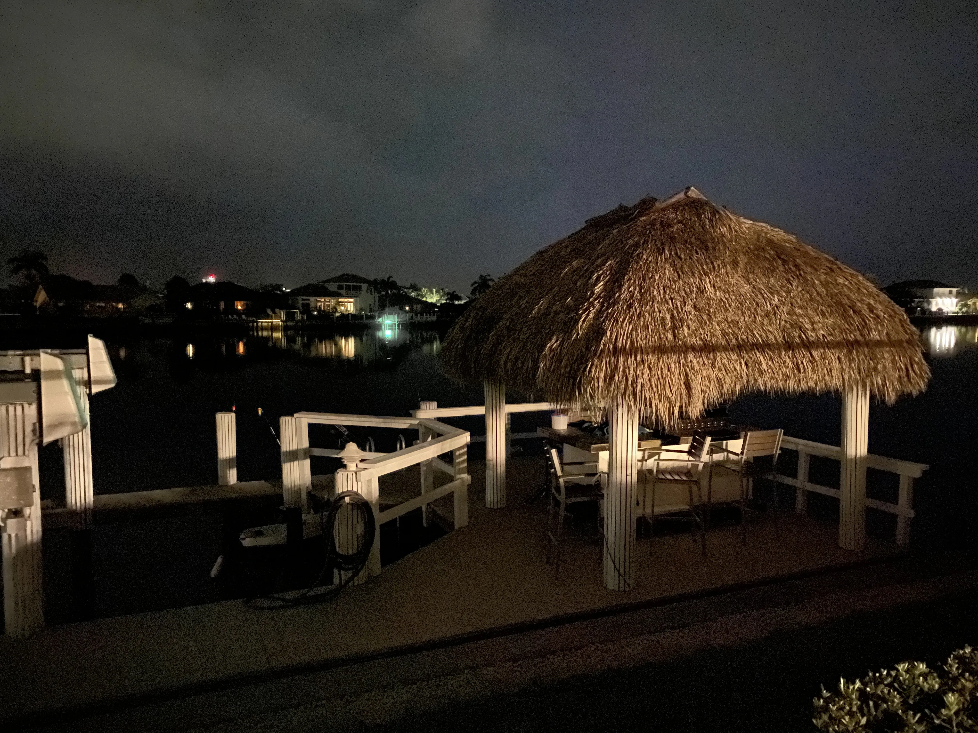 Tiki bar with thatched roofs lit up at night
