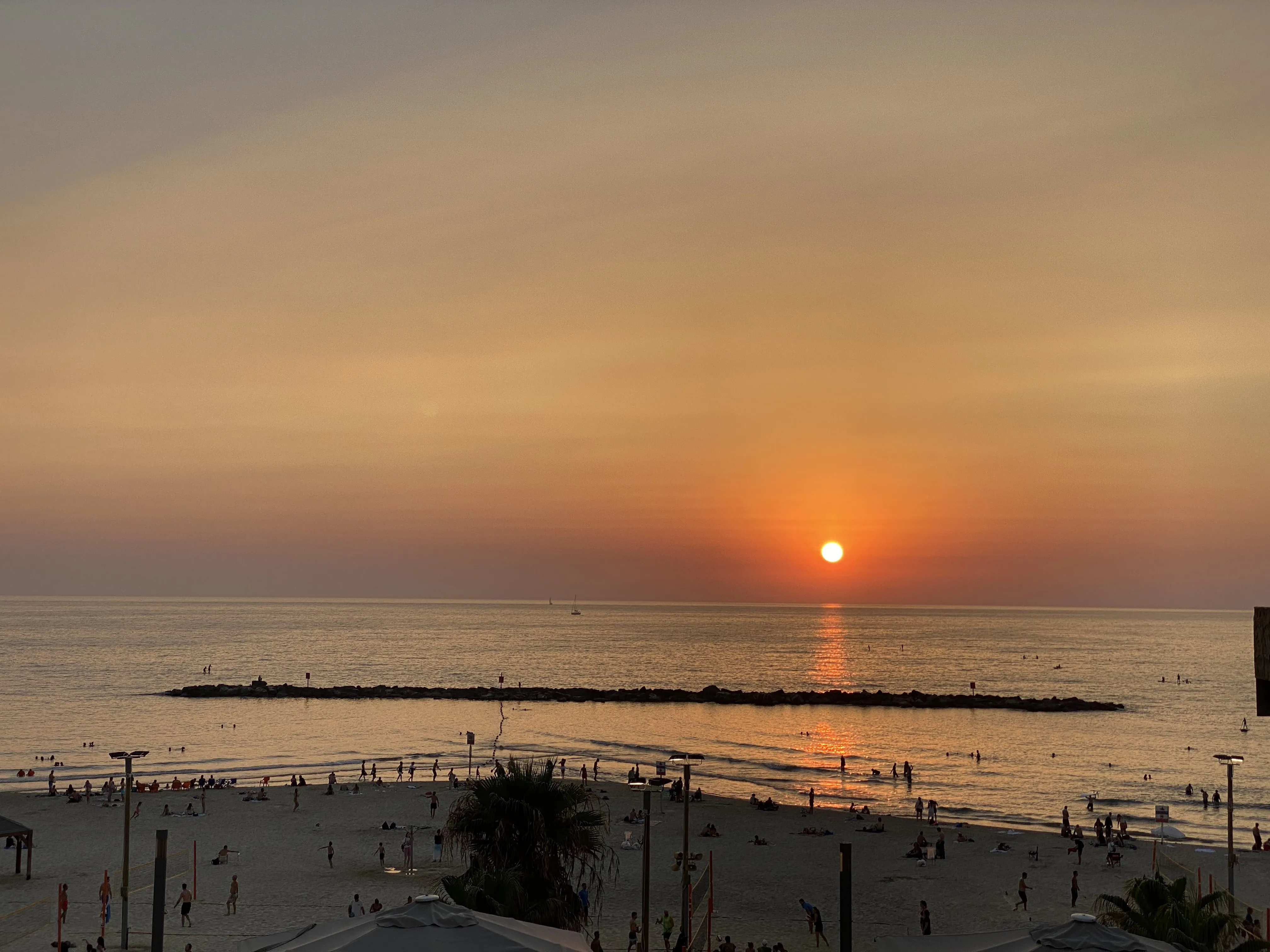Footprints in the sand as the sun sets over the beach